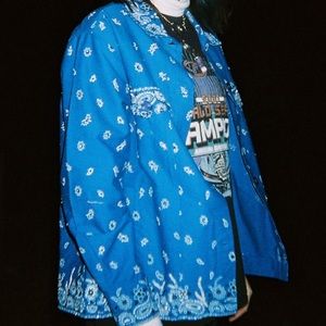 blue paisley patterned coat with stitched sparkles